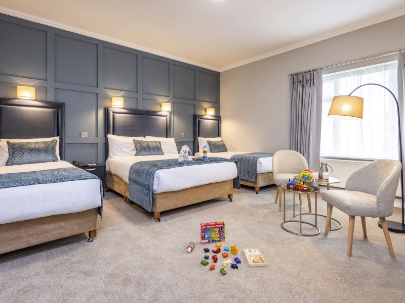Large bedroom at The Sandymount Hotel with two double beds and one single bed