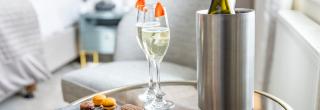 Prosecco and chocolates in a room before the guest's arrival
